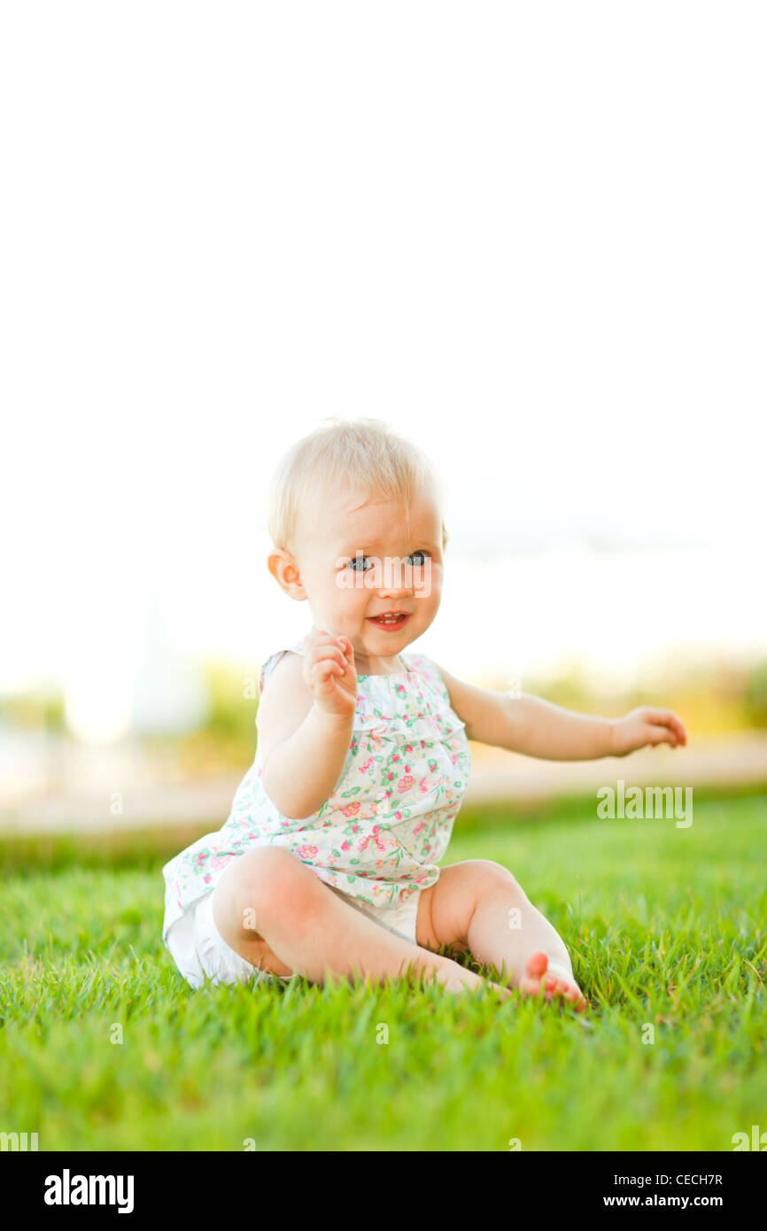 Cute baby playing on grass Stock Photo Alamy