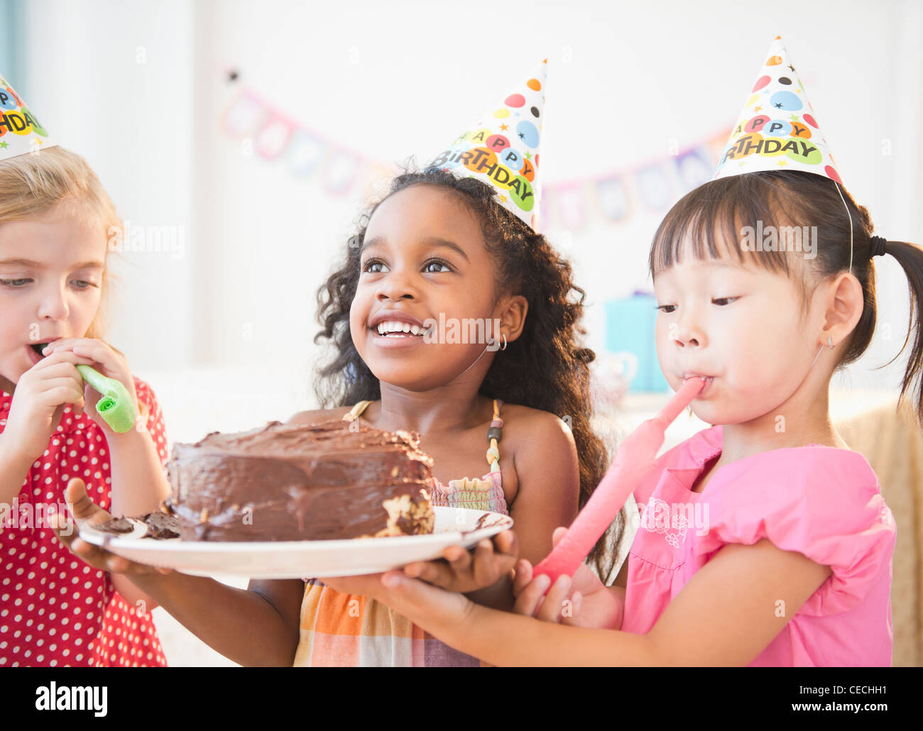 Girls holding birthday cake together Stock Photo Alamy