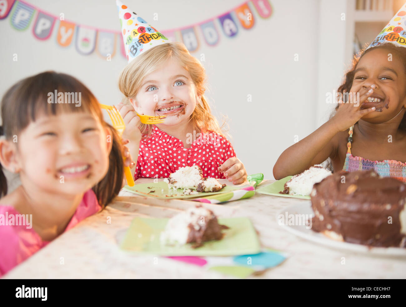 Girls enjoying cake at birthday party Stock Photo Alamy