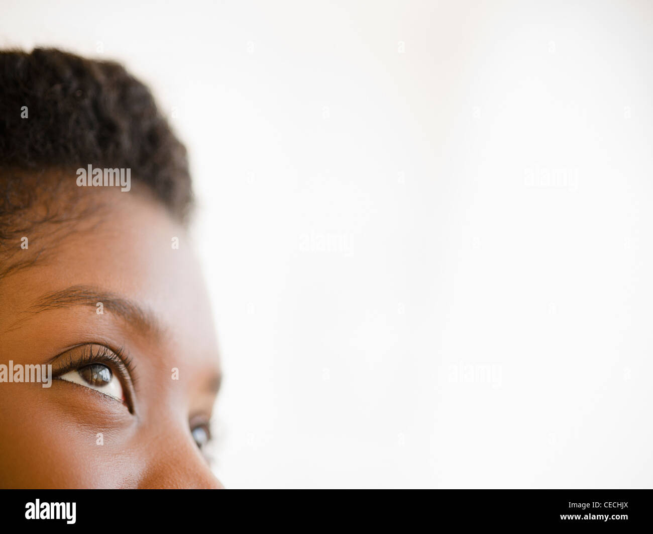 Close up of Black woman looking upwards Stock Photo