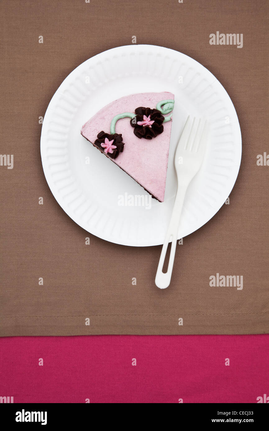 Slice of birthday cake on paper plate Stock Photo