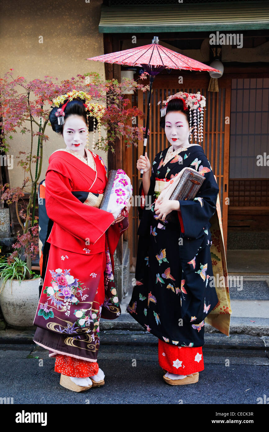 Japanese woman dressed in traditional clothing holding umbrella Stock