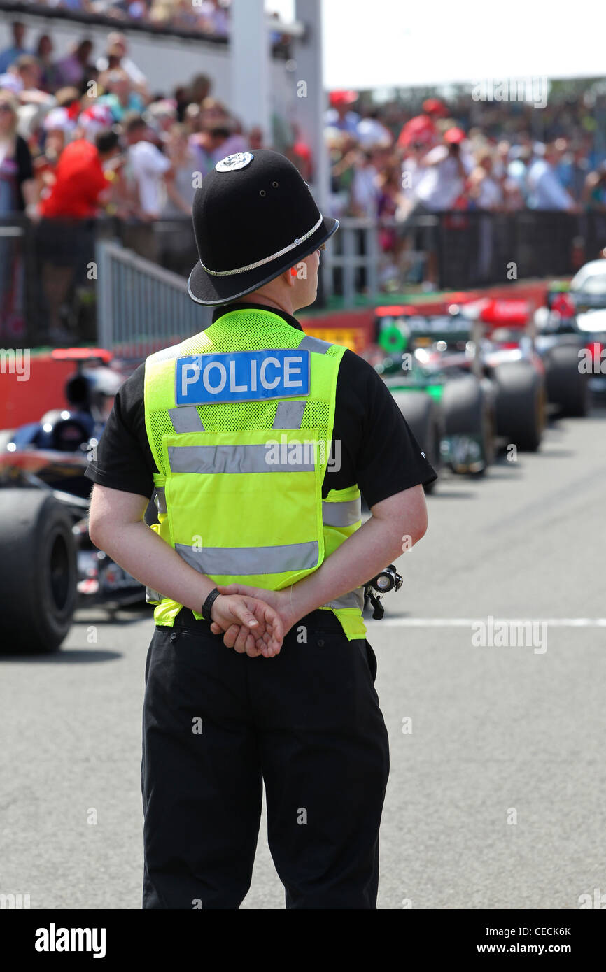 British Police guard the entrance to parc ferme at the Formula One British Grand Prix Stock Photo