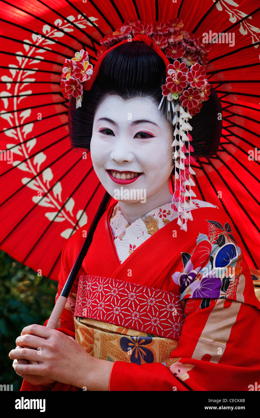 Head Shot Of Japanese Woman In Traditional Makeup Holding Red Umbrella Stock Photo Alamy