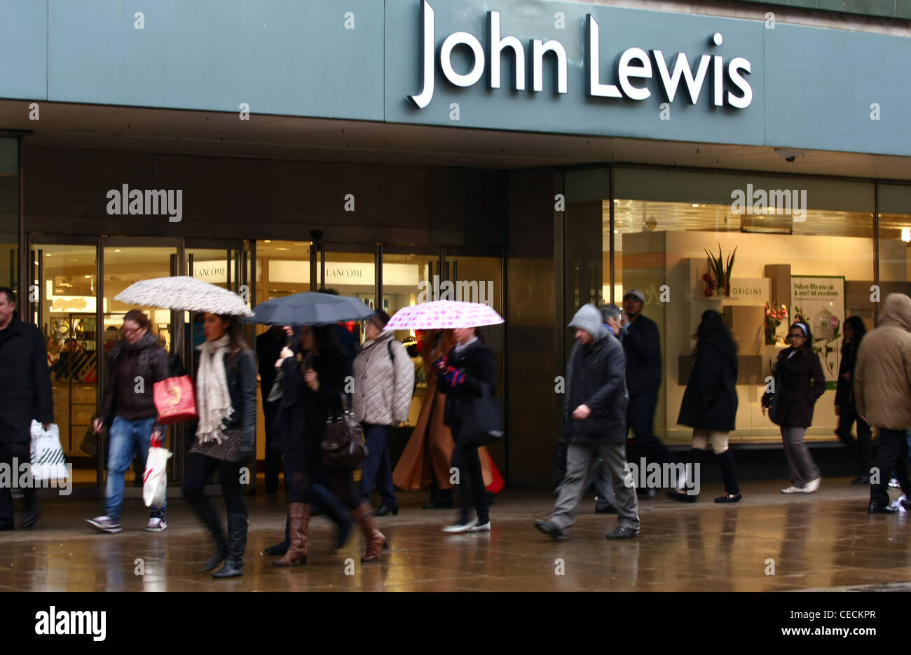 An entrance to the John Lewis store in oxford Street with people passing Stock Photo