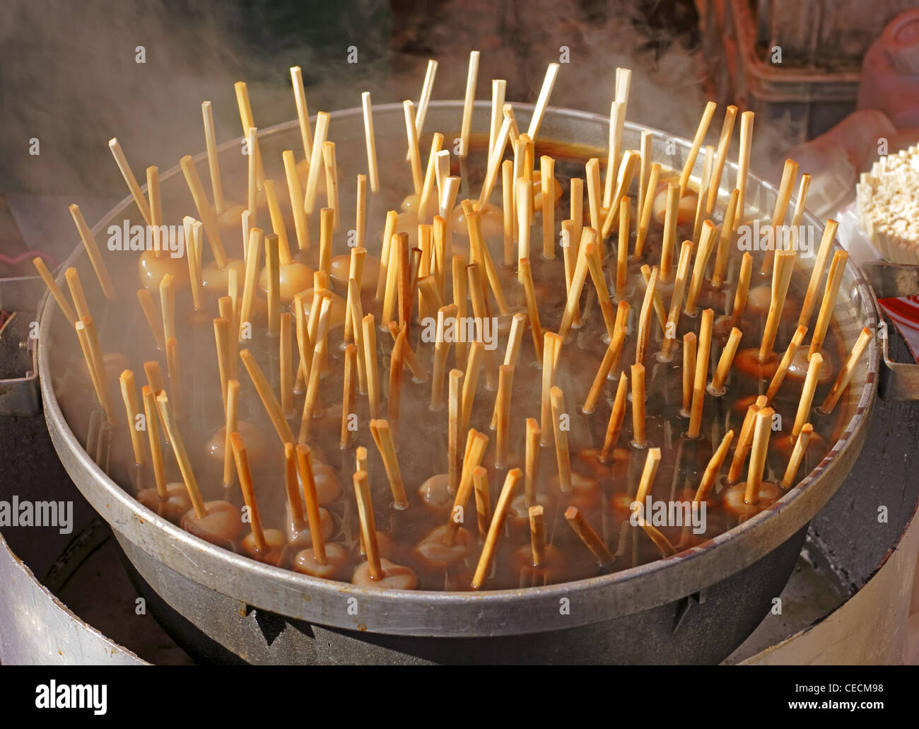 Image of a big bowl with Japanese rice balls boiling-specific Japanese street festival food. Stock Photo