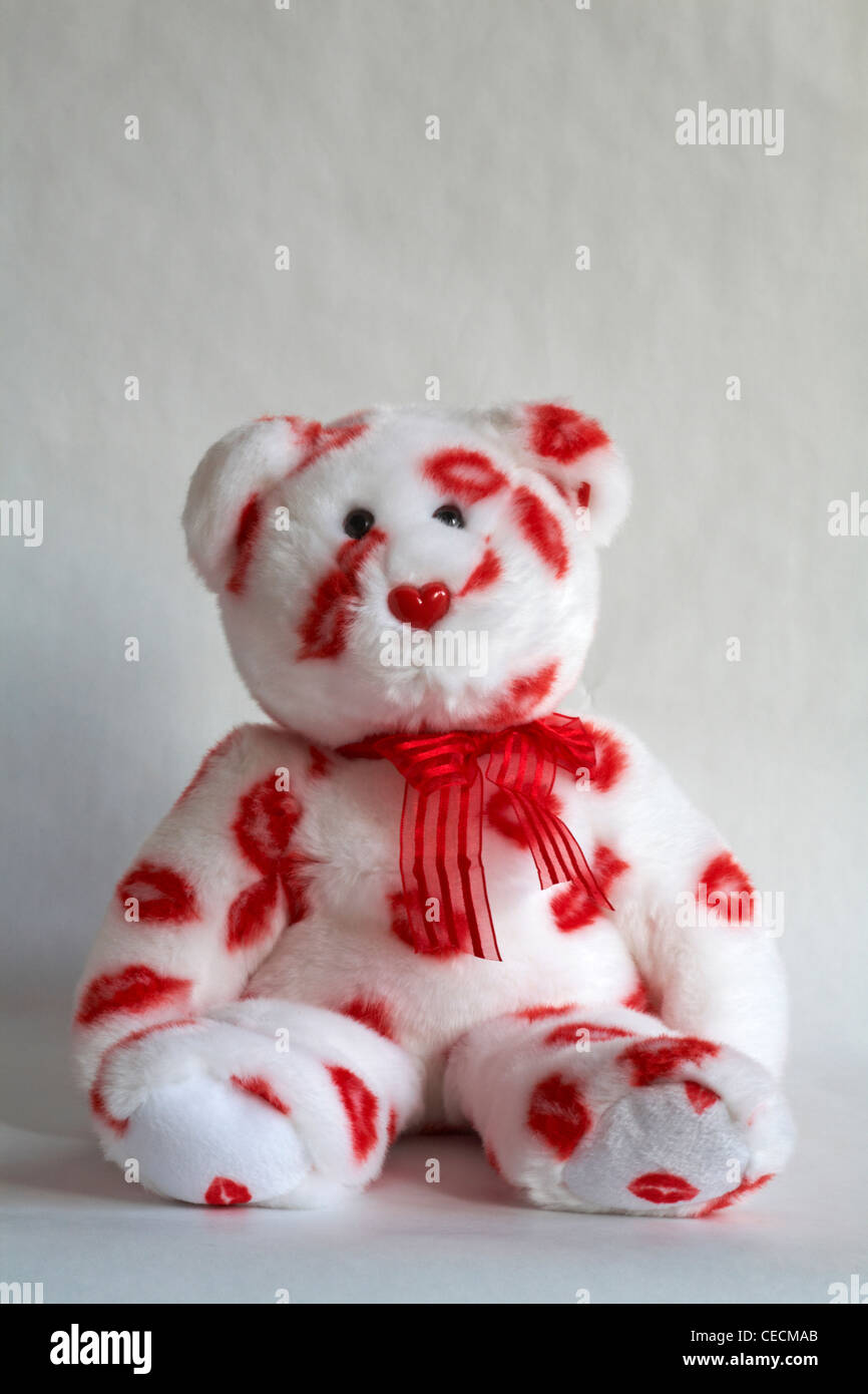 Smooch the bear - Ty beanie buddy cuddly white teddy bear with red lipstick marks and red ribbon isolated on white background Stock Photo