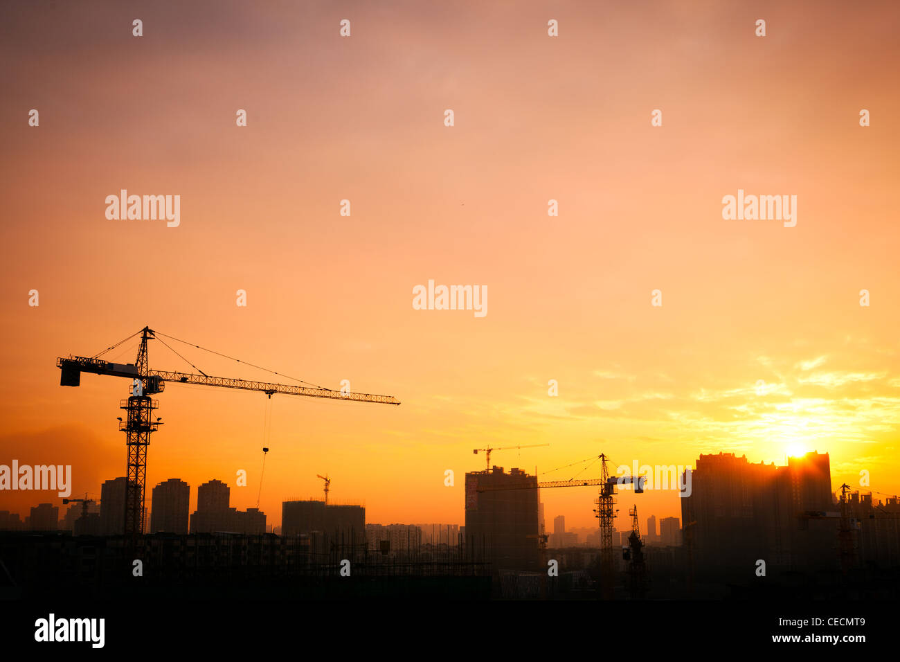 Silhouette of the tower crane on the construction site with city ...
