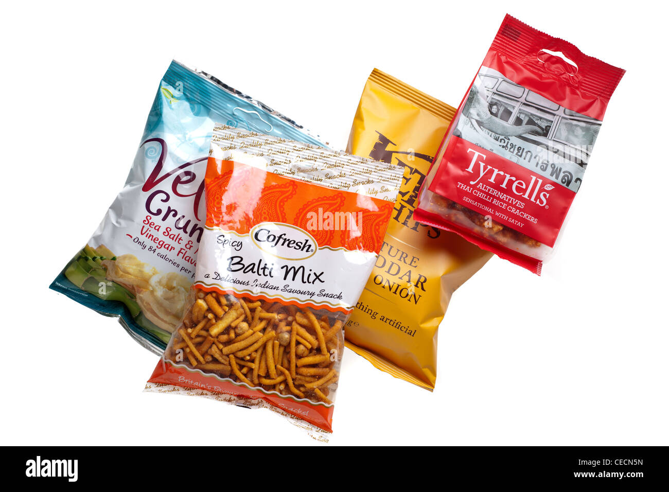 Four bags of crisps rice and crackers savoury snacks Stock Photo