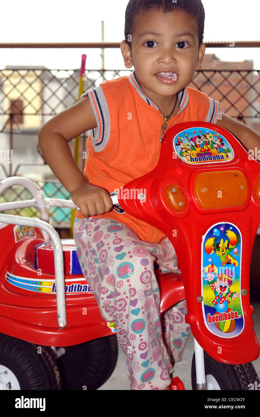 Kid riding tricycle Stock Photo Alamy