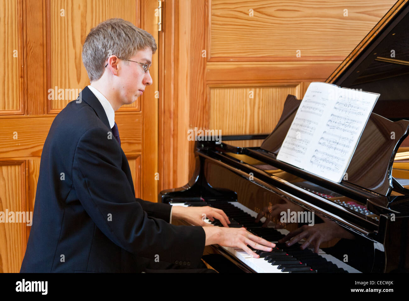 Young man playing a grand piano Stock Photo