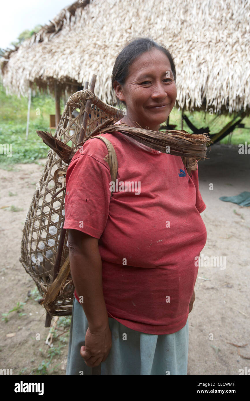 Amerindian woman with a traditional woven carrying basket, Rewa, Rupununi, Guyana, South America Stock Photo