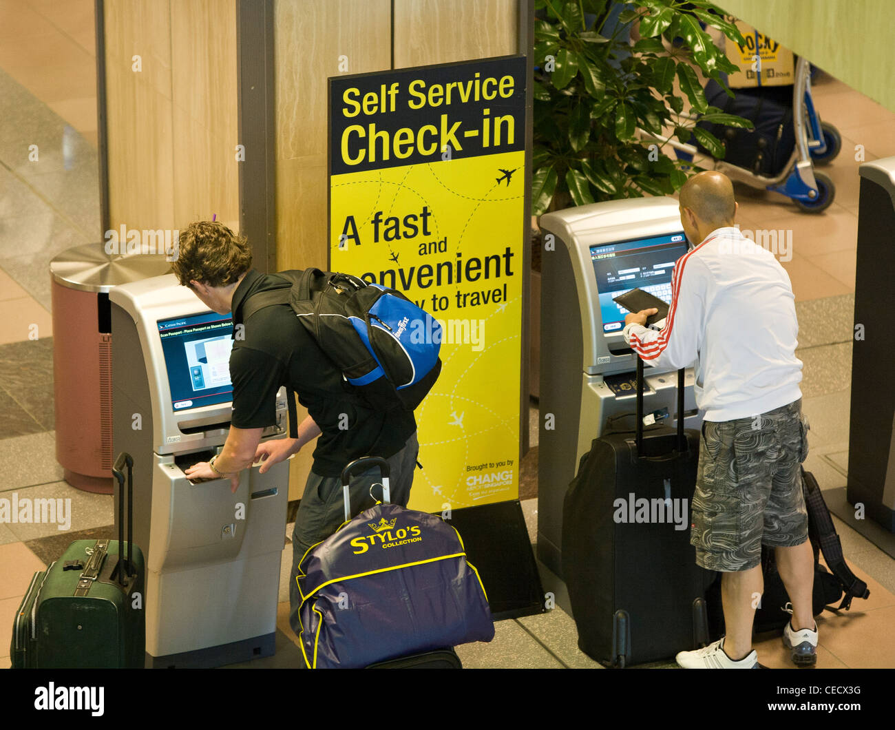 Passengers checkin at self service kiosks at Changi Airport in