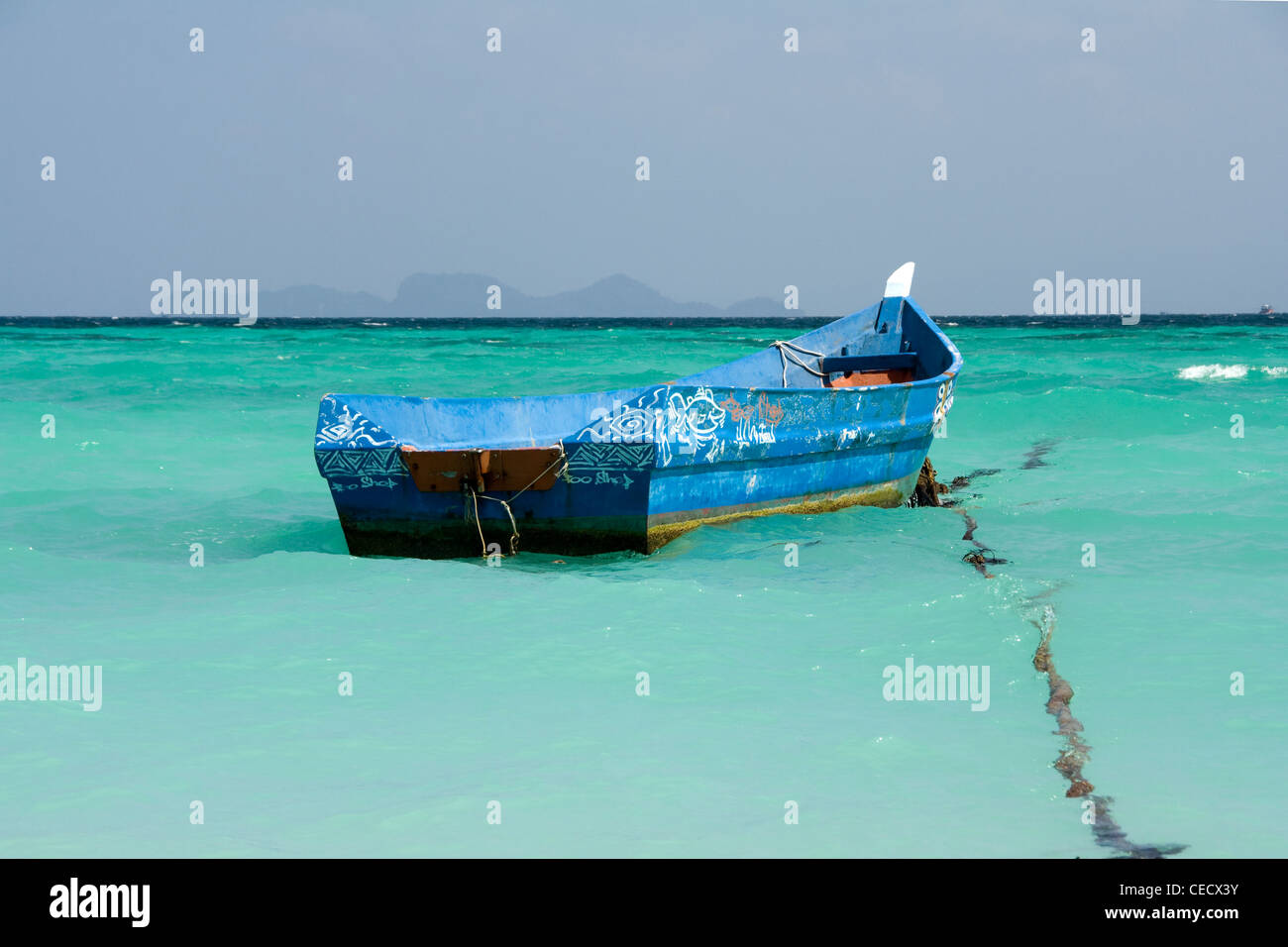 Blue boat in clear blue water Stock Photo