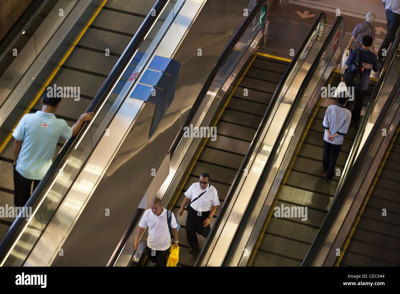 People ride a moving walkway at Changi Airport in Singapore Stock Photo ...