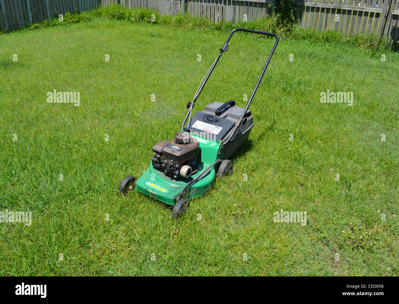 Lawn mower in long grass Stock Photo Alamy