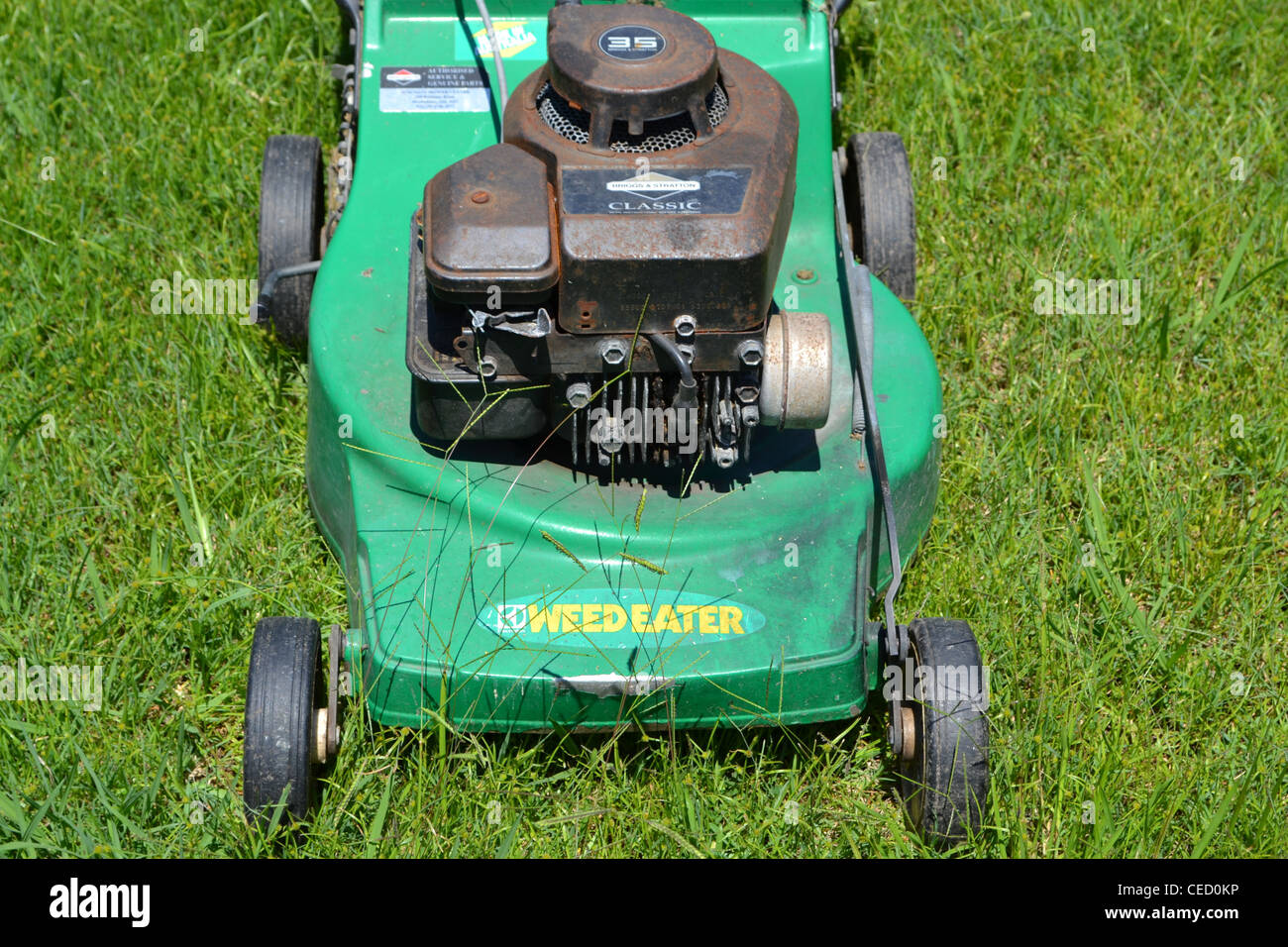 Lawn mower in long grass Stock Photo Alamy