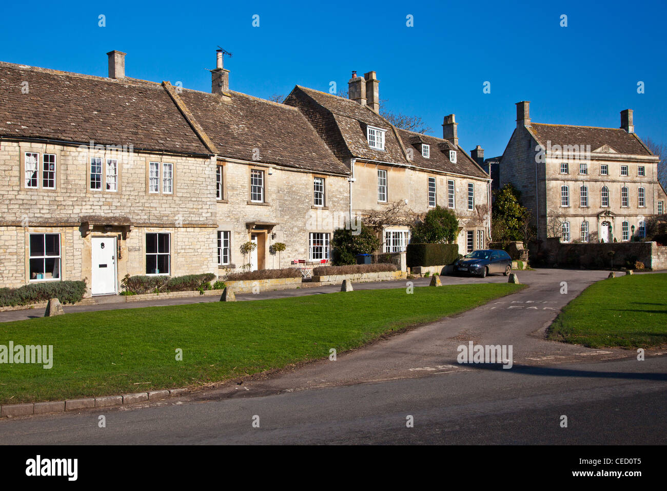 Cotswold stone houses and cottages around the green in the typical English country village of Biddestone, Wiltshire, England, UK Stock Photo