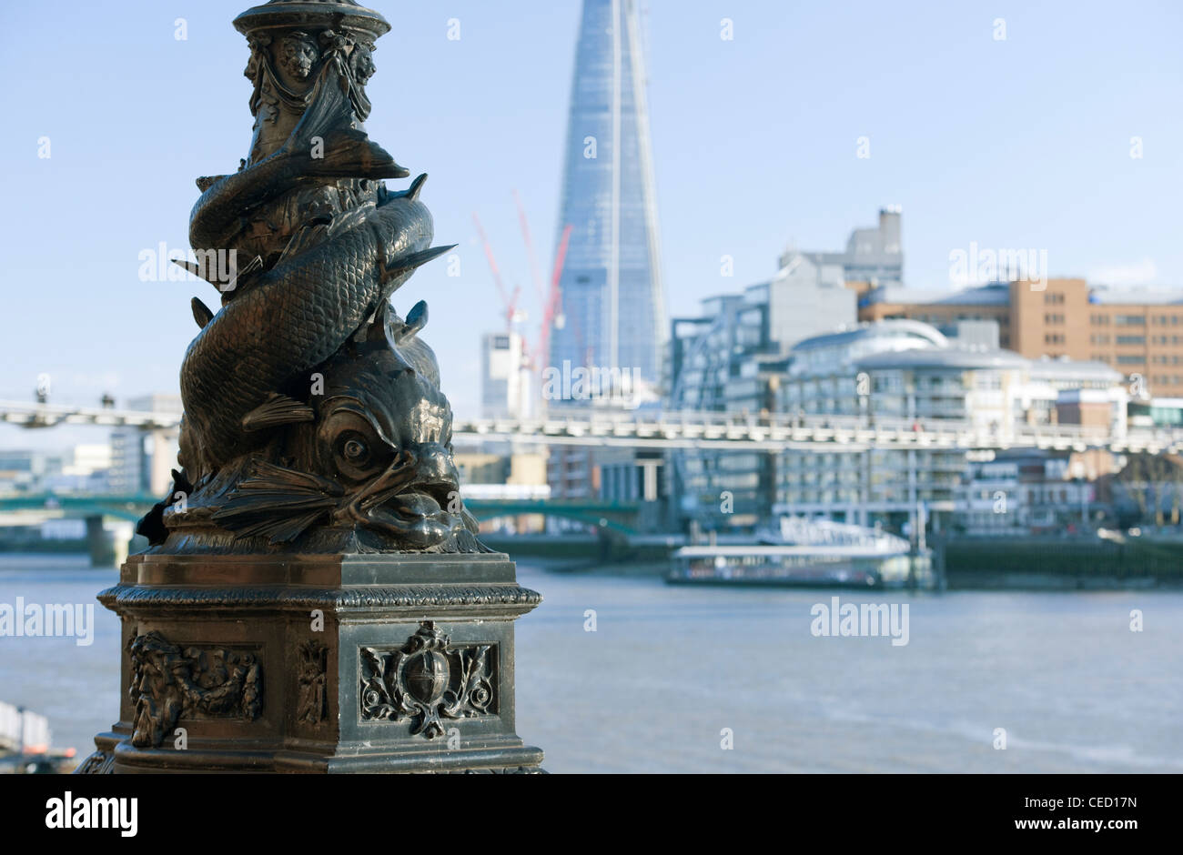 Cast iron Victorian lamp base in shape of a fish with The Shard building in the background on a clear sunny day Stock Photo