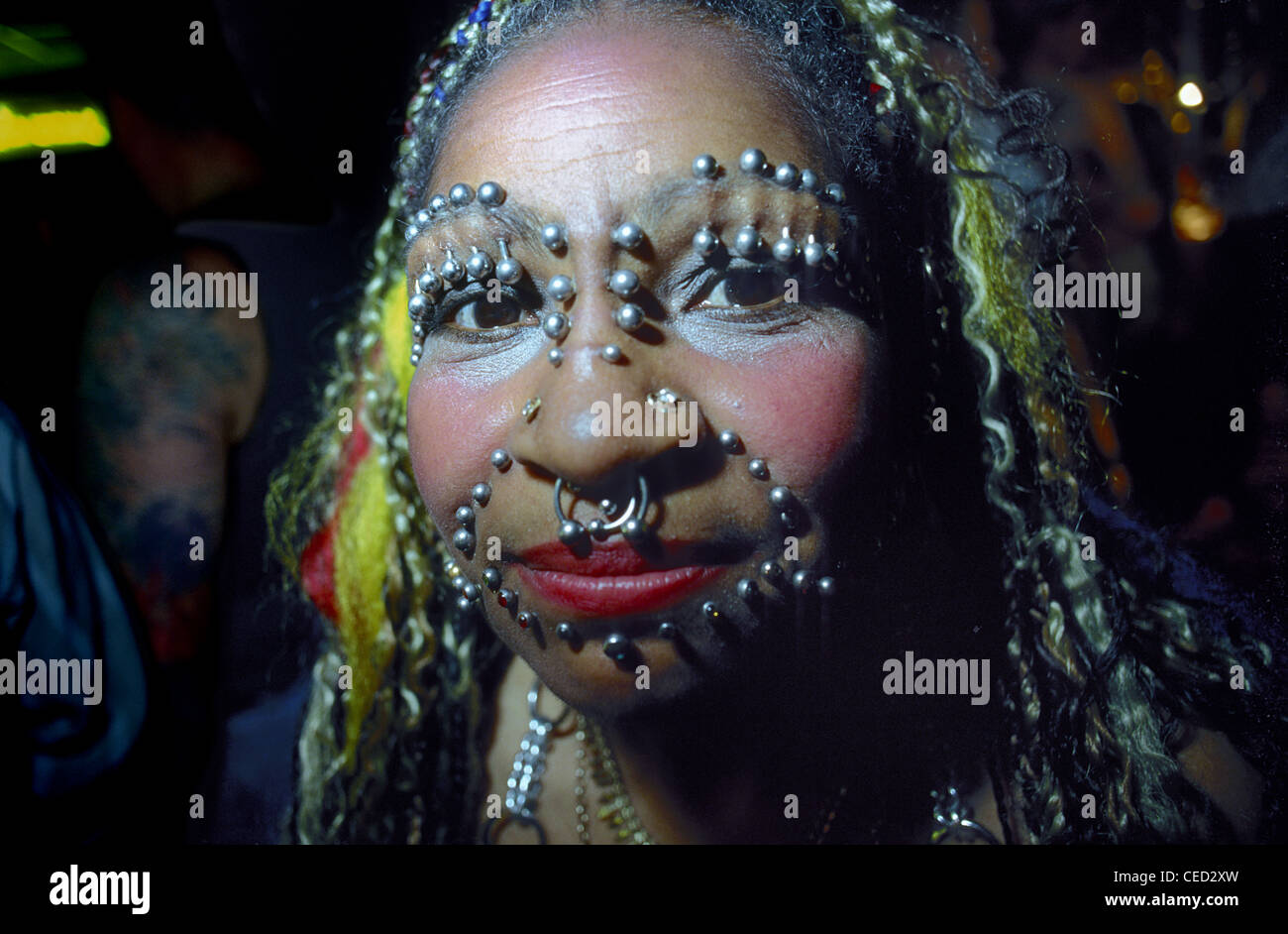 A face with lots of piercings at a tattooing festival in London Stock