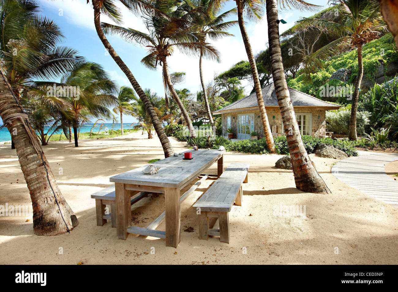 Island paradise beach private exclusive Mustique Caribbean palm trees secluded no people sky sand sea deserted sunny sunshine ocean hammock blue Stock Photo