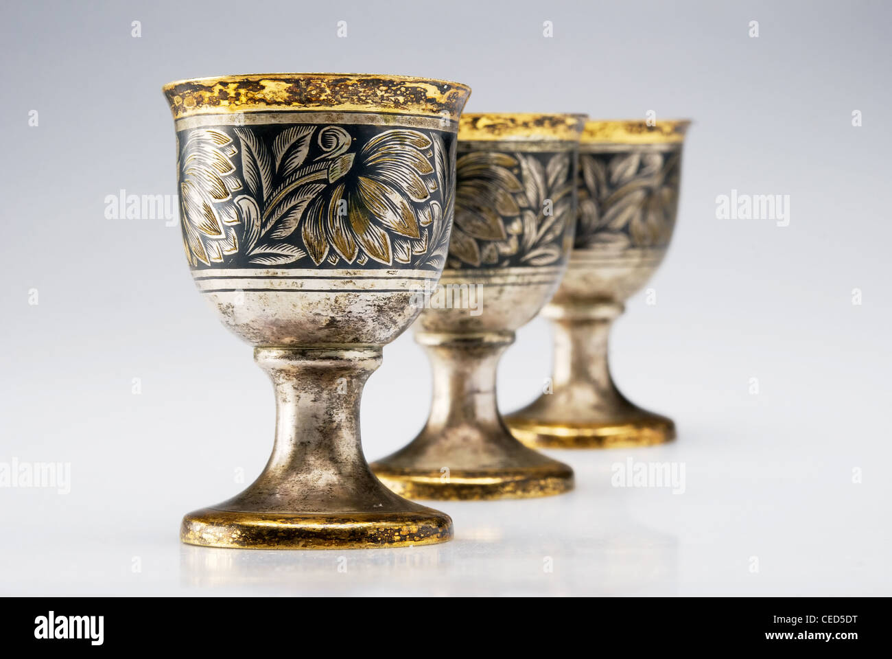 Three ancient wine cup in a line isolated over white background Stock Photo