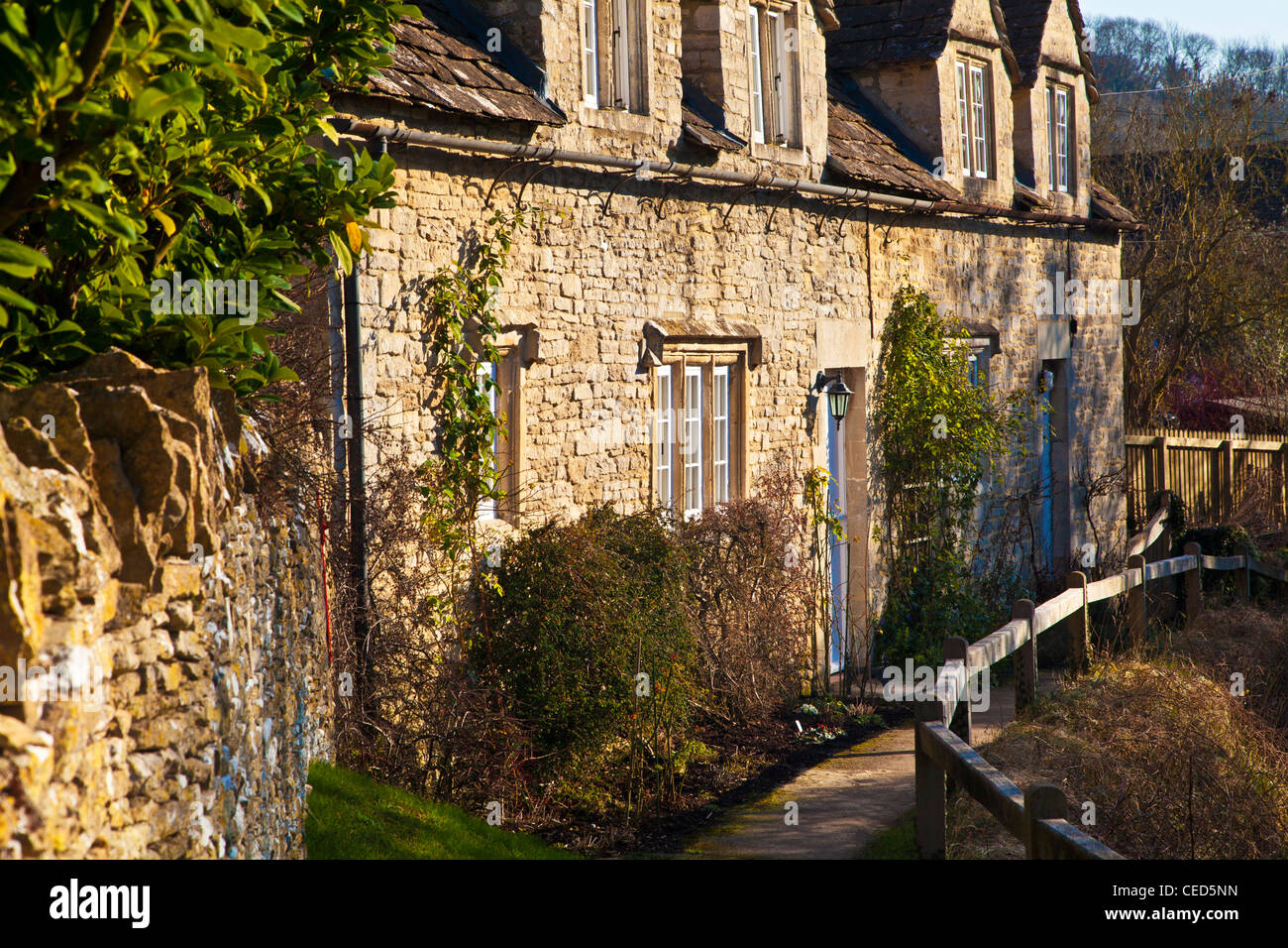 A row of Cotswold stone cottages along a footpath in the village of Slaughterford, Wiltshire, England, UK Stock Photo