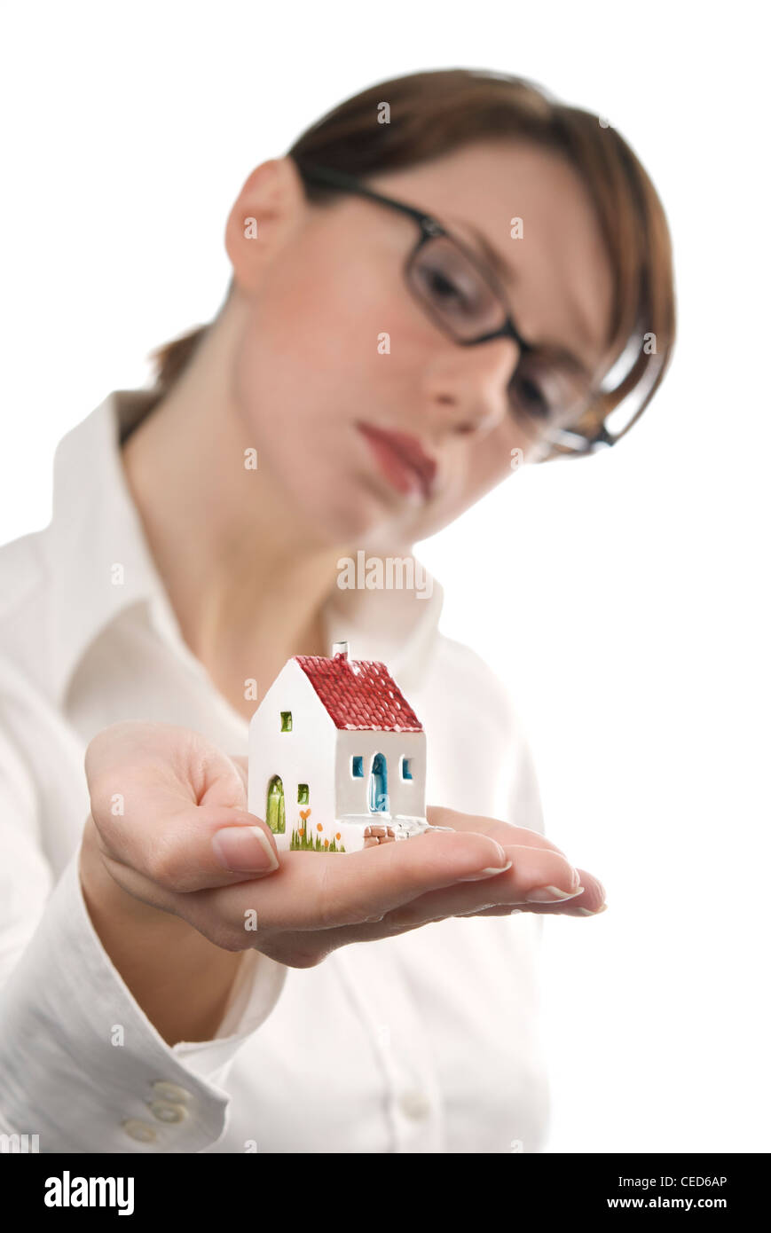 Image of business woman holding toy house on her palm Stock Photo - Alamy