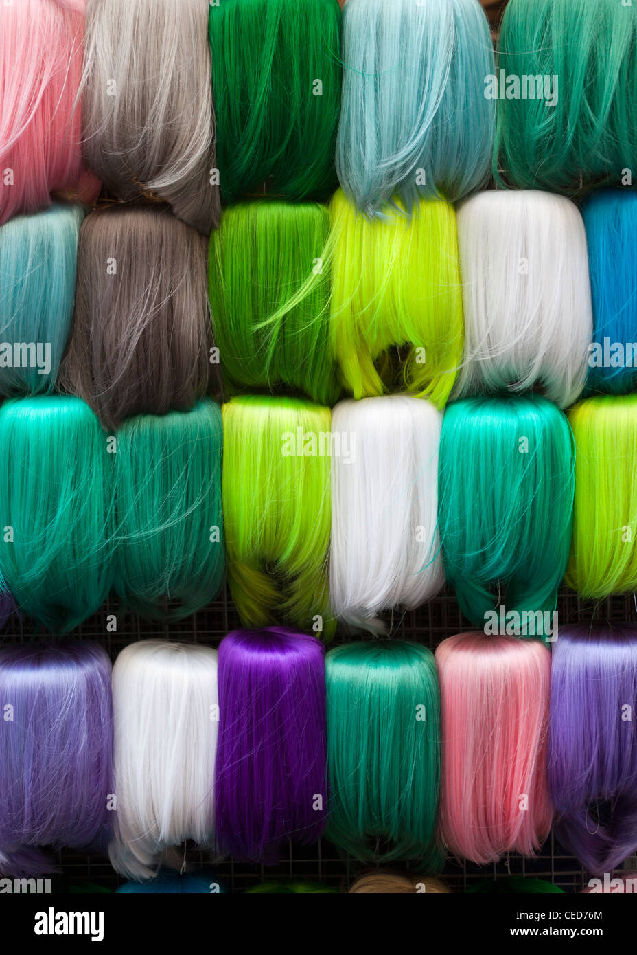 Display of colourful Wigs on sale at Pratunam Market Bangkok Stock Photo