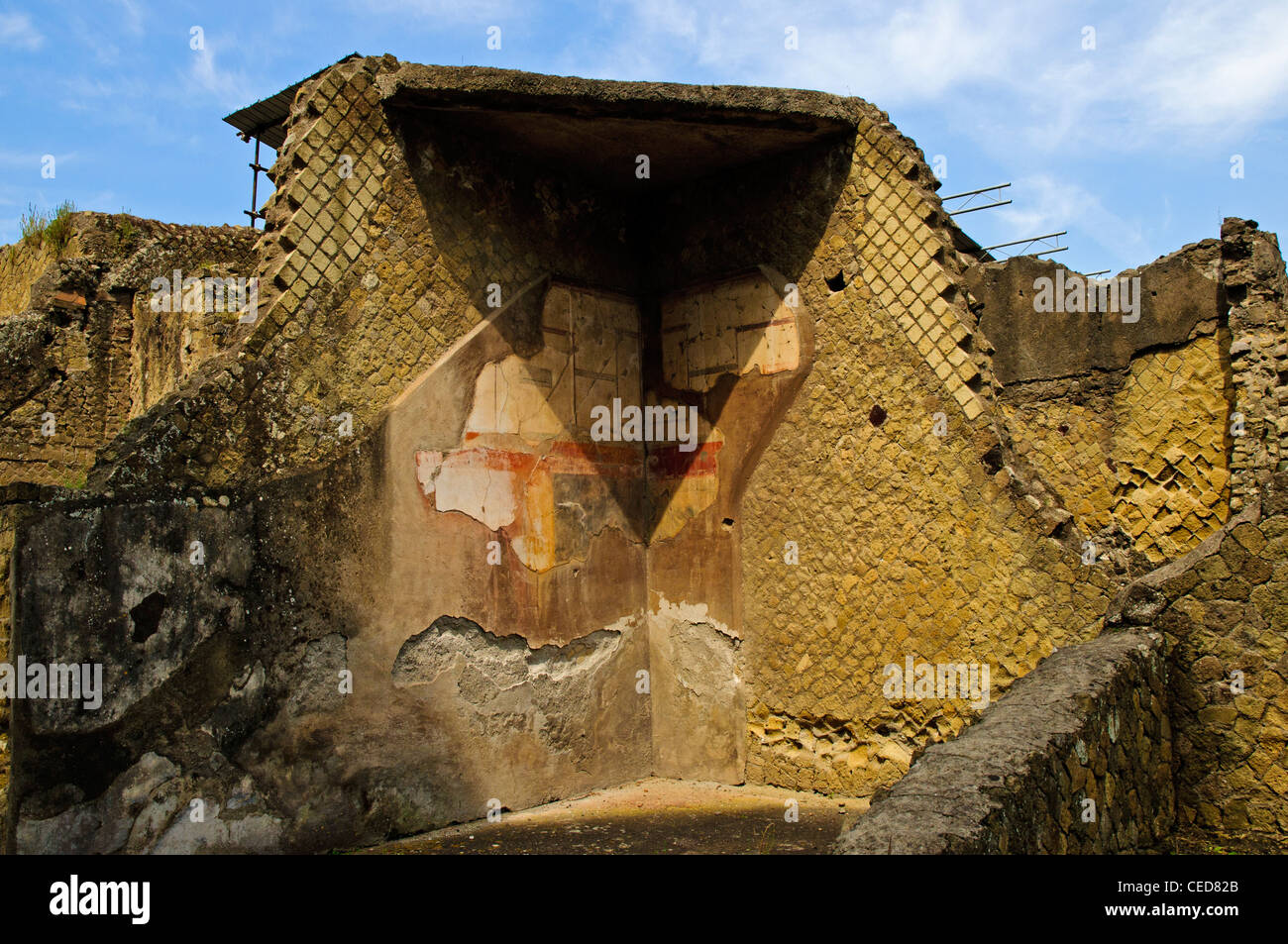 The ruins of a building still showing remnants of plaster decorated in the fourth style with colourful architectural motifs Stock Photo