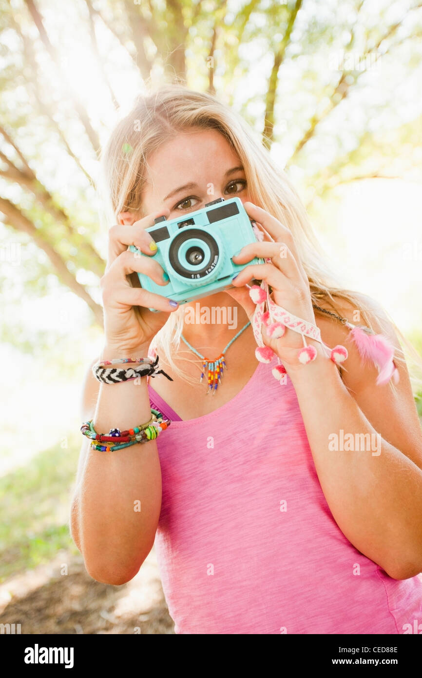 Caucasian woman taking photographs Stock Photo