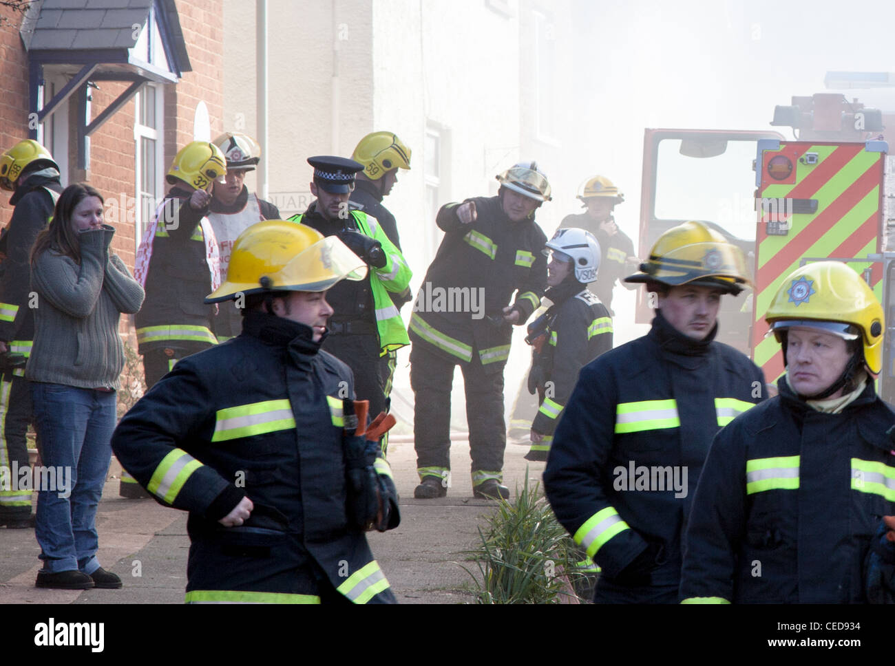 Fire fighters at a fire in a row of thatched cottages in Crediton, Devon Stock Photo