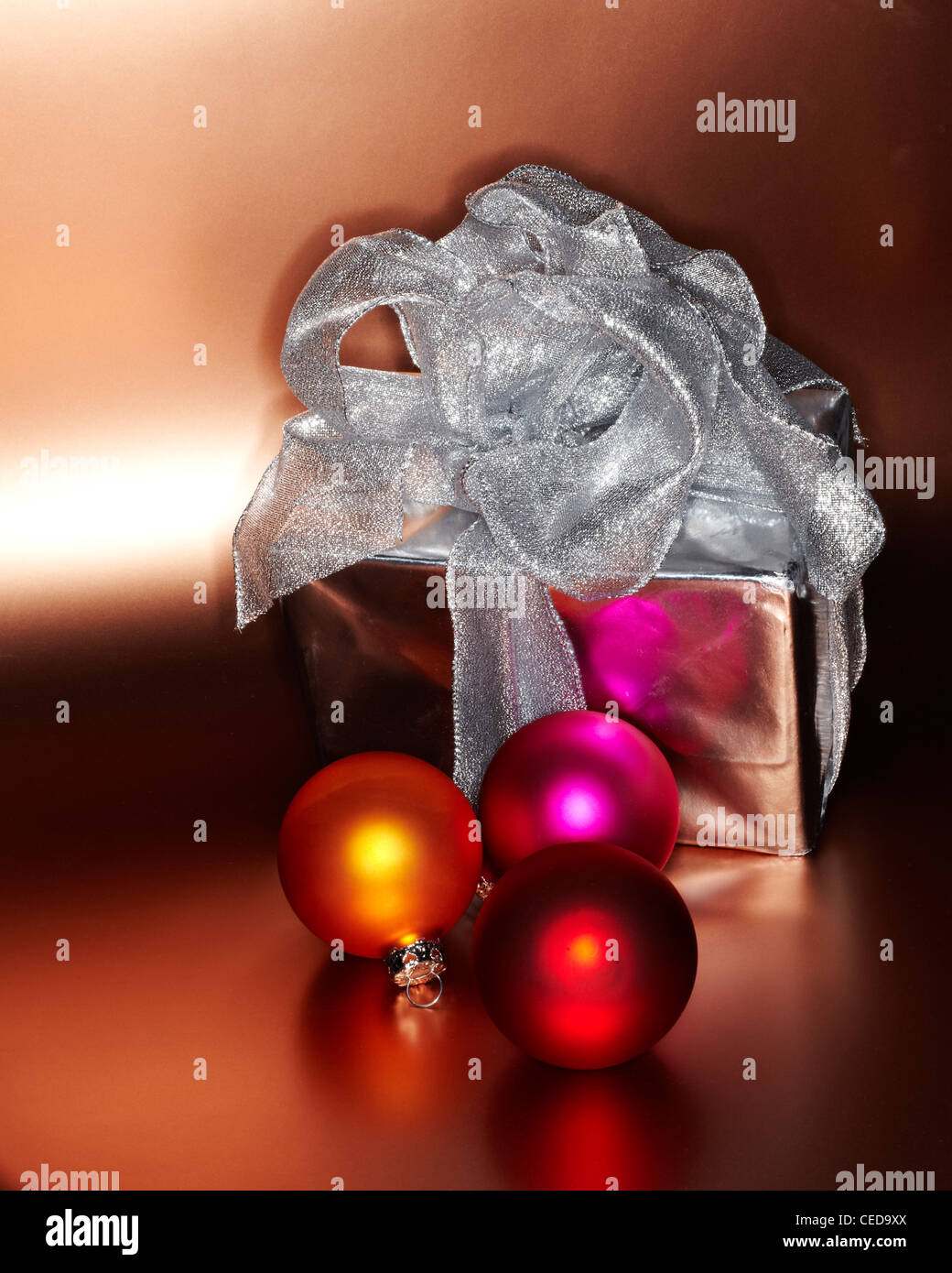 Festive Christmas gift with colored ornaments Stock Photo