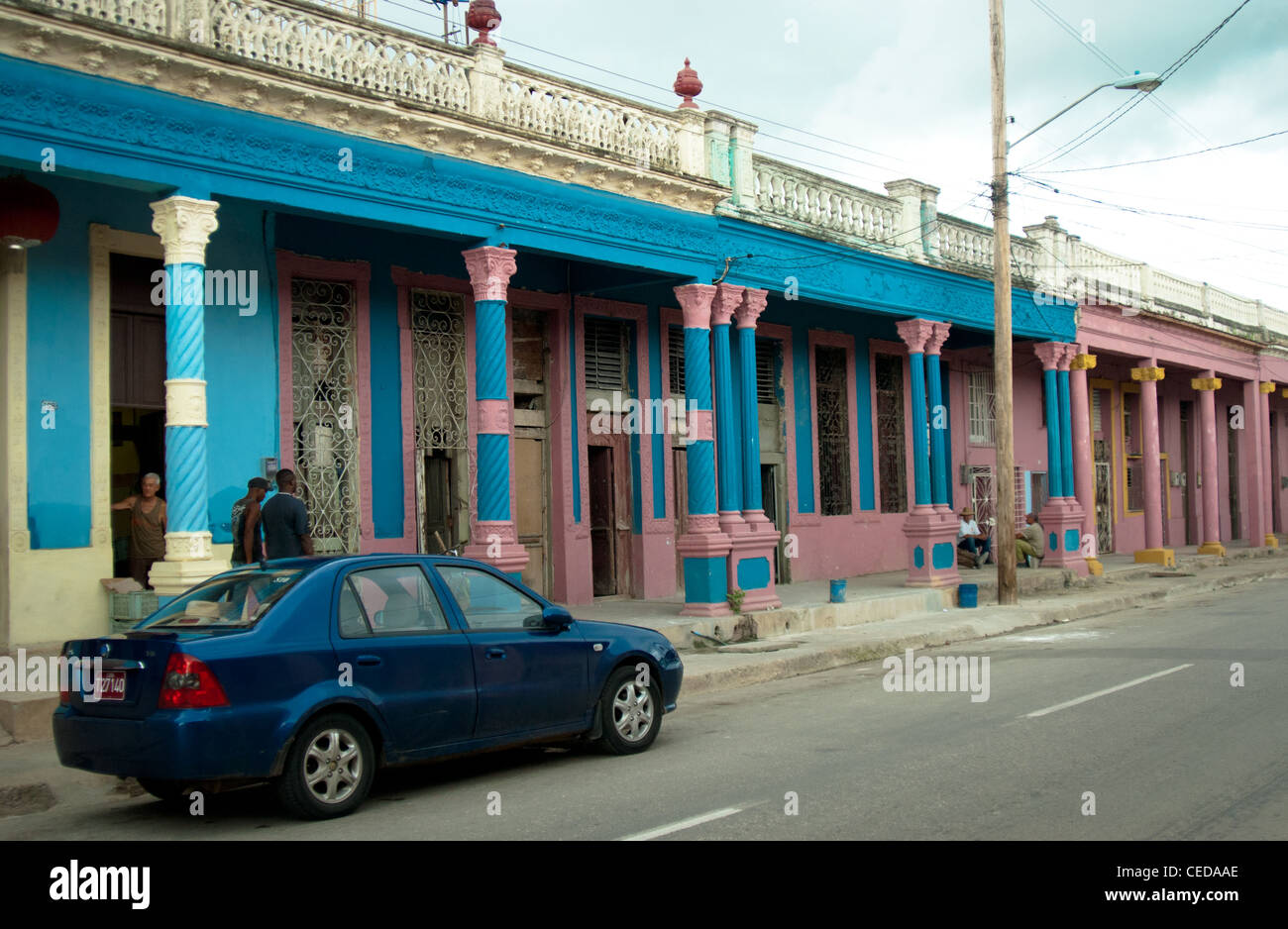 rented car parked outside a building with colonial arches in Ciego De Avila, Cuba Stock Photo