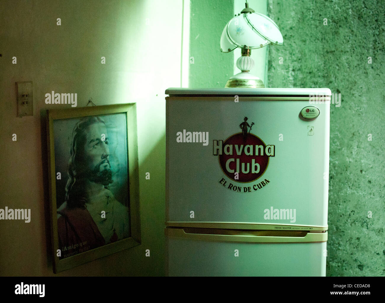 Picture of Jesus and a fridge with Havana Club logo in a private Cuban house Stock Photo
