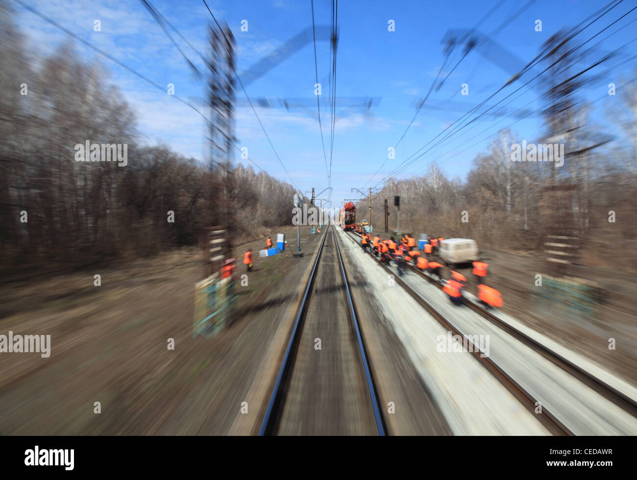 View on railway with maintenance crew from moving train, motion blur Stock Photo