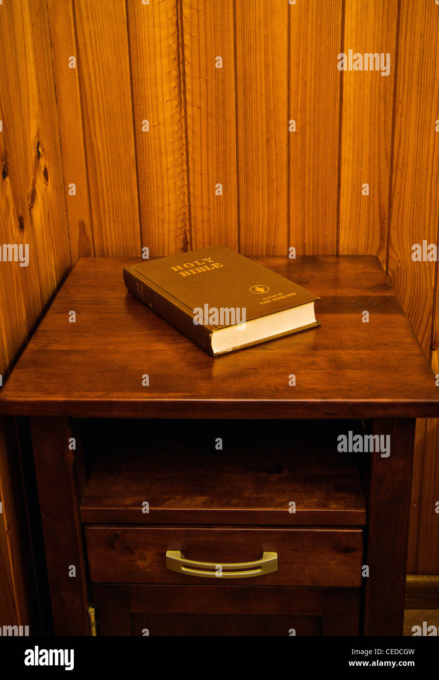 bible on bed side table in cheap hotel room Stock Photo