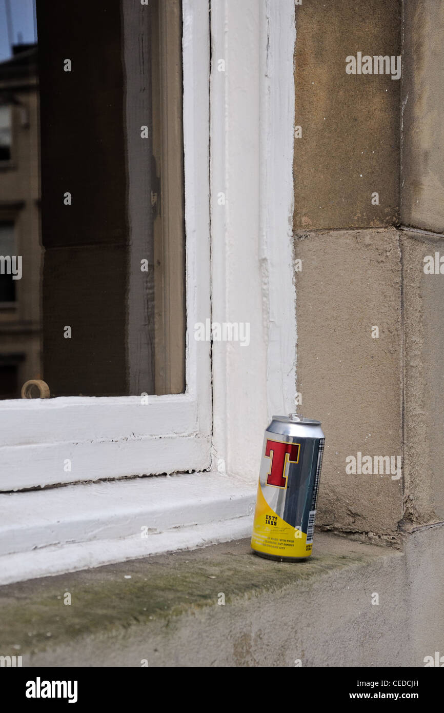 Empty beer can on a city centre window ledge. Stock Photo
