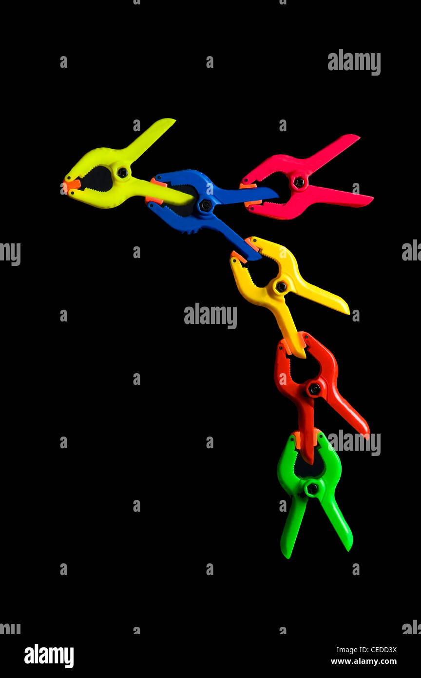 Series of hand clamps connected to each other in a form of unity Stock