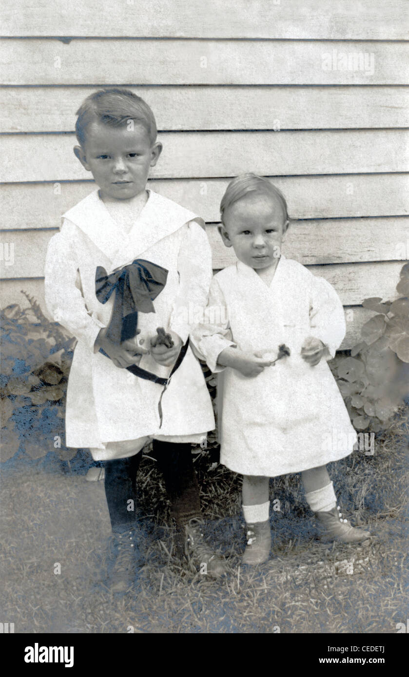 Vintage photo of two young children dressed in Confirmation clothing, circa early 1900s. Stock Photo