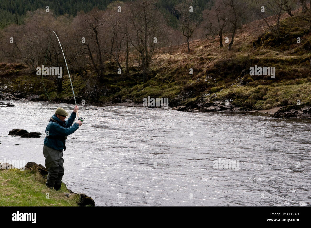 Man Salmon Fishing on the bank of the River Oykel, Sutherland, Scotland Stock Photo