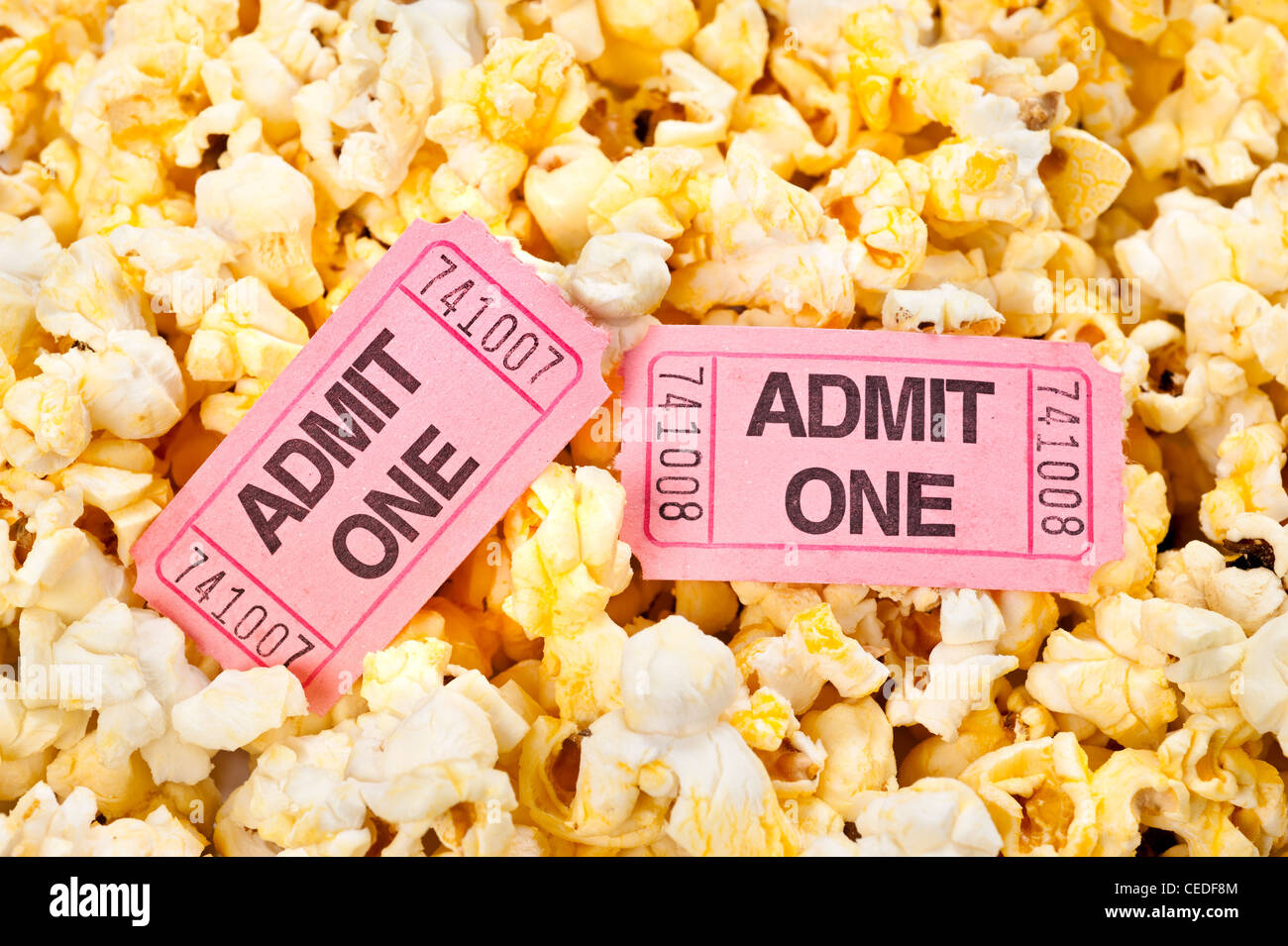 Movie tickets in a pool of freshly popped popcorn Stock Photo
