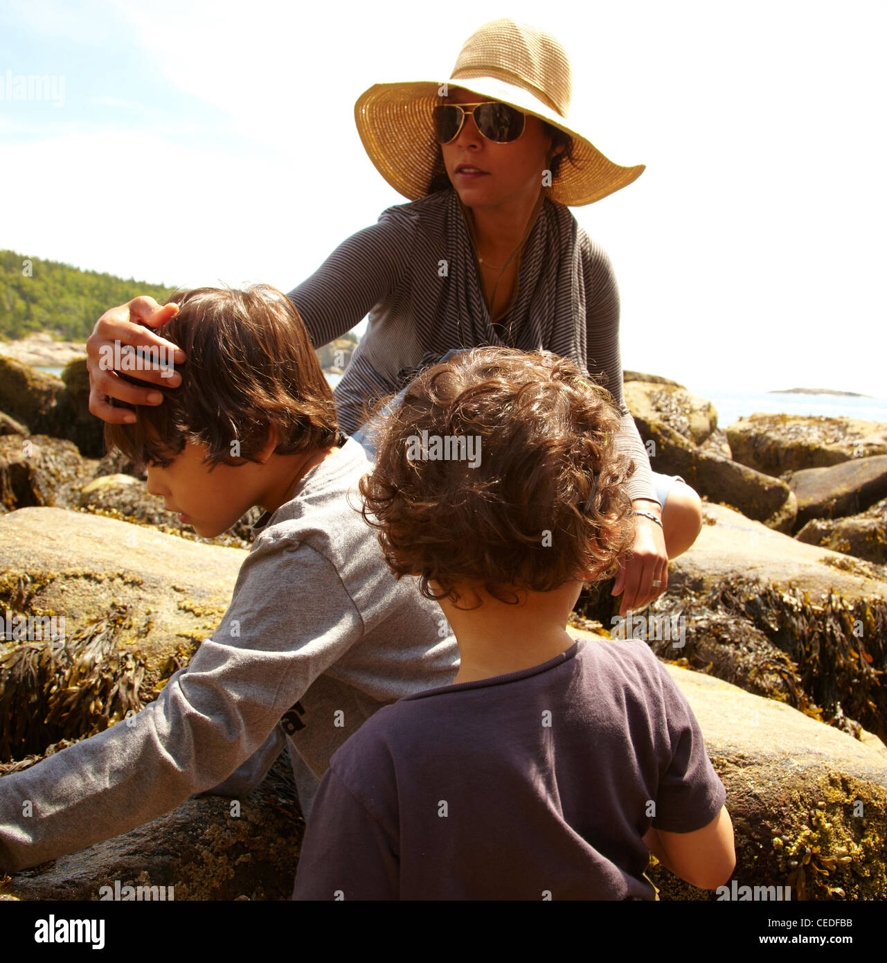 Mom With Rocks Mother and sons sitting on rocks Stock Photo - Alamy