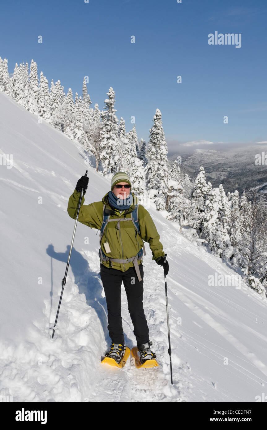 A young woman snowshoeing in the Chic Chocs, Parc de la Gaspesie, Quebec Stock Photo