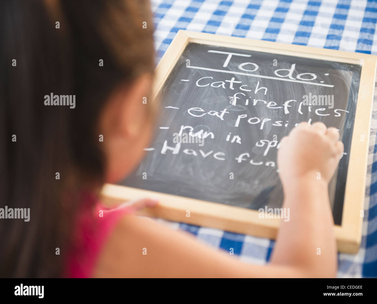 Korean girl writing to do list on blackboard Stock Photo