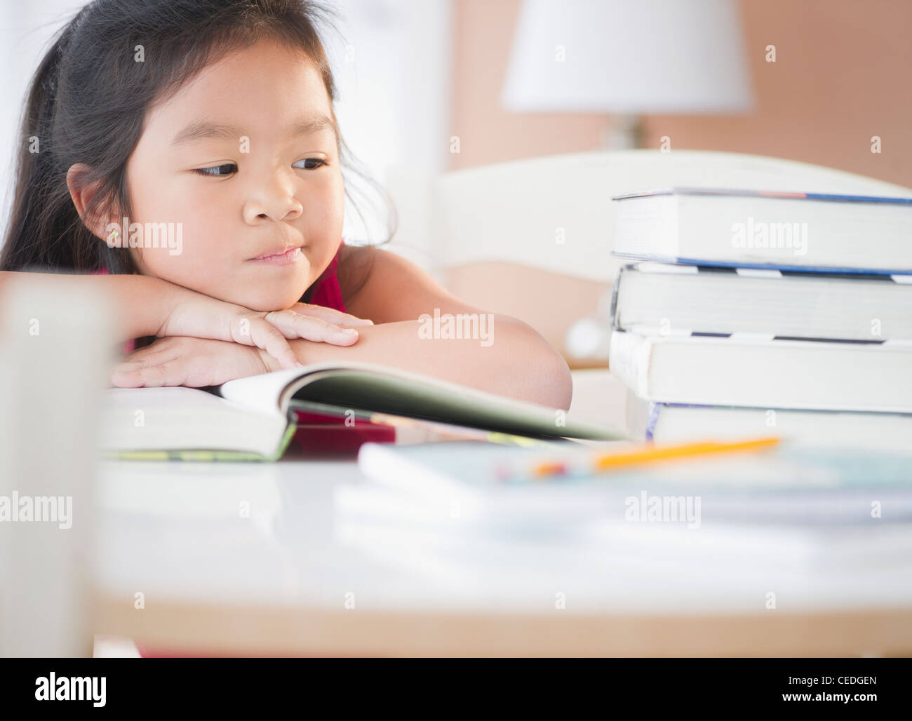 Bored Korean girl doing homework Stock Photo