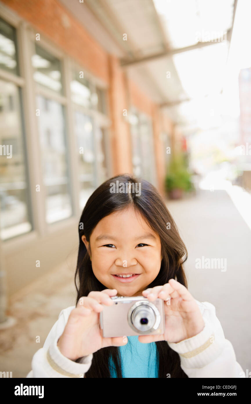 Korean girl taking photographs with digital camera Stock Photo