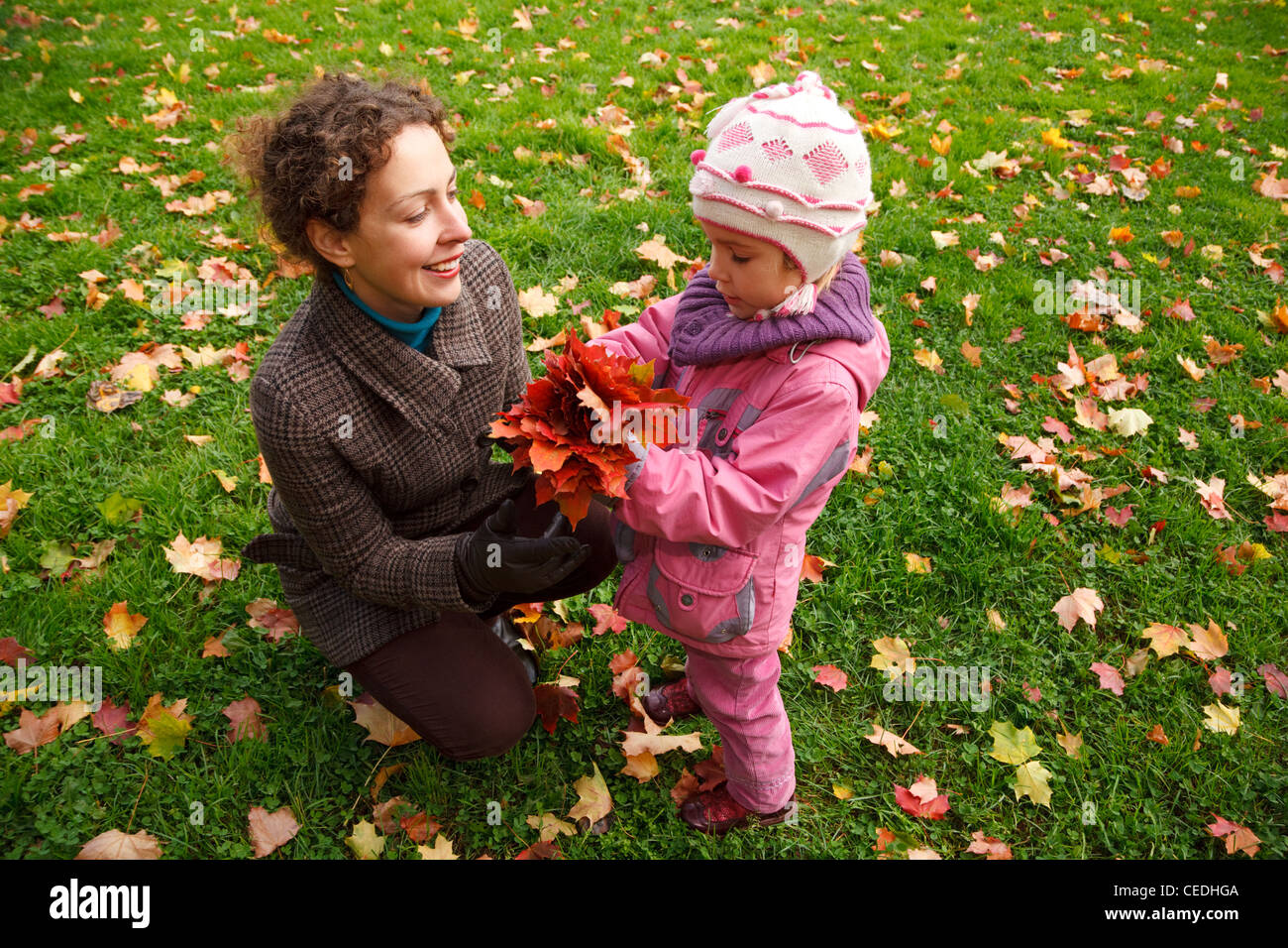 Mother and daughter walking in autumn park Stock Photo - Alamy