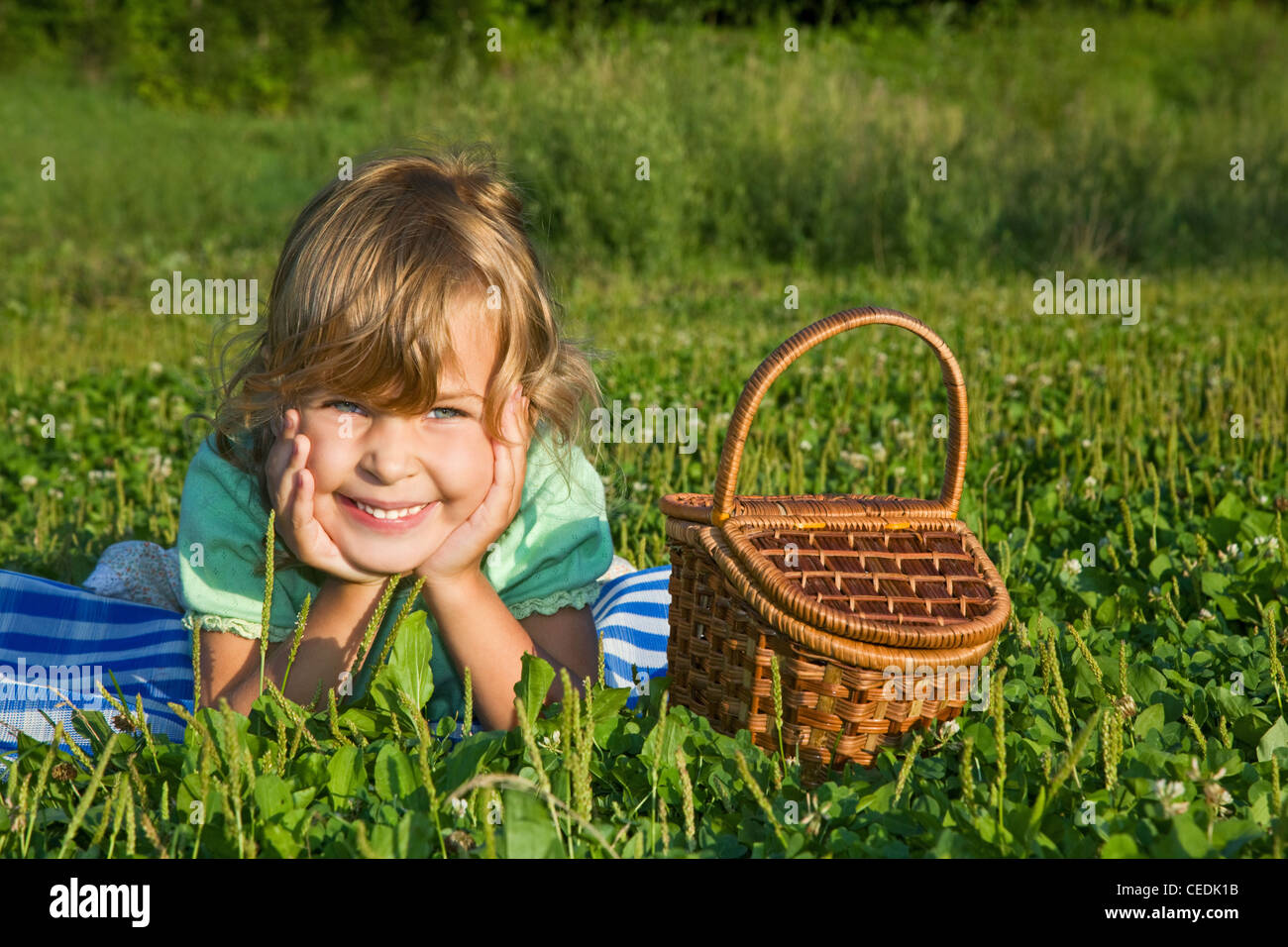 pretty Little Girl with basket on glade Stock Photo Alamy