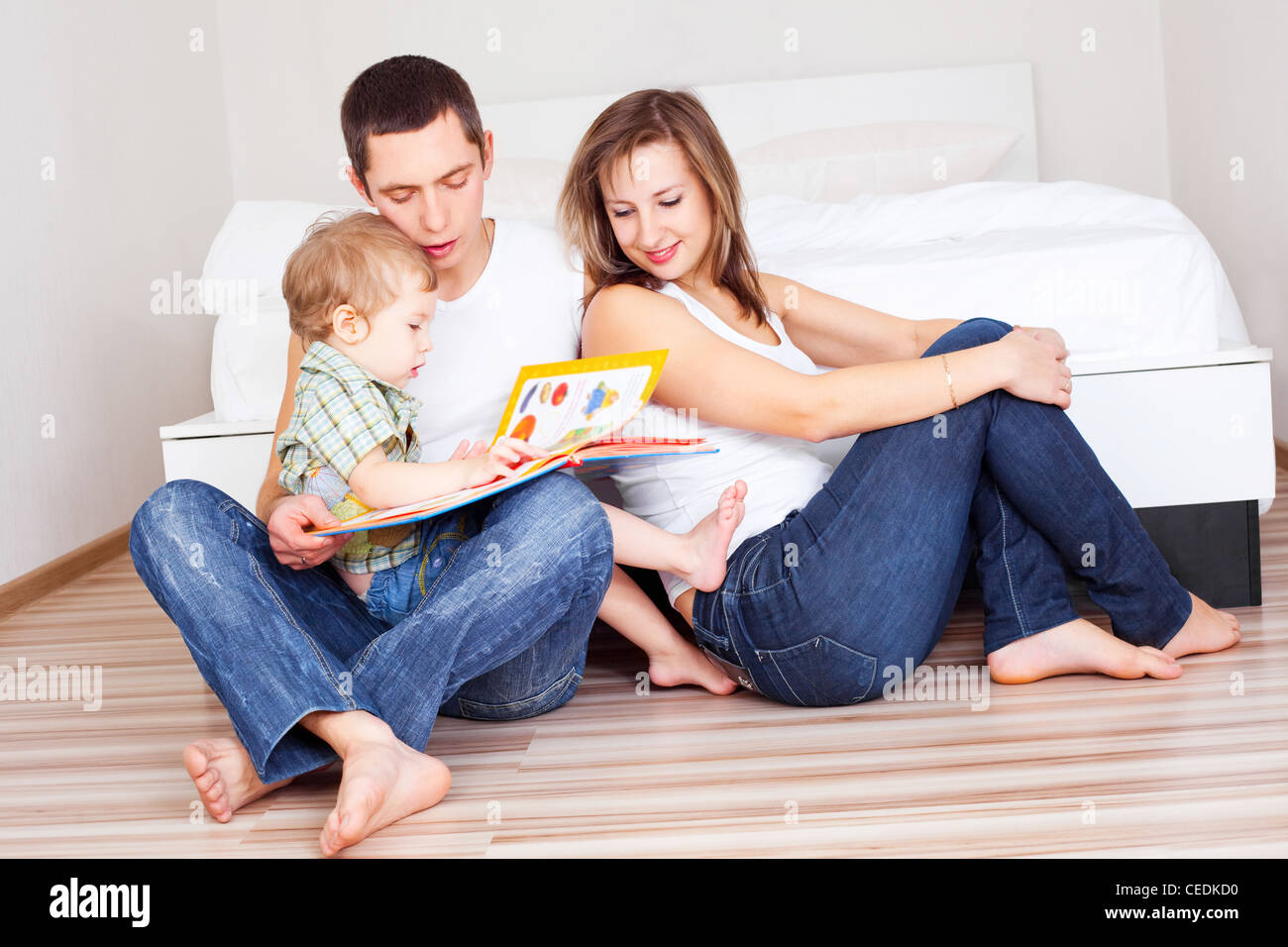 happy family reading a book at home Stock Photo - Alamy